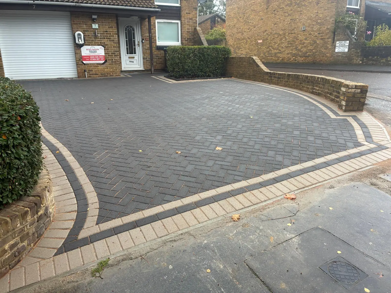 Grey herringbone block paving driveway with curved contrasting borders